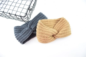 Close-up of thick knitted twist headbands in dark grey and camel for winter warmth