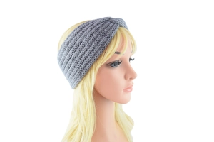 Close-up of grey knitted cross twist headband with soft textured wool pattern