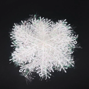Detailed view of white snowflake ornaments with laser iridescent glitter for Christmas decor