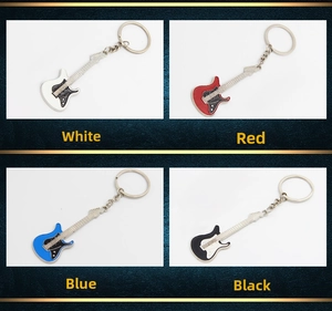 Detail view of colorful guitar keychains in white, red, blue, and black metal finishes