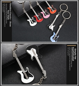 Detailed macro view of colorful electric guitar keychains on black textured leather