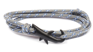 Detail of nautical braided bracelet with matte black shark anchor hook in grey and blue