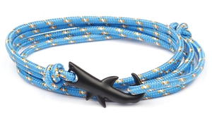 Macro detail of blue braided rope bracelet with matte black shark shaped anchor clasp
