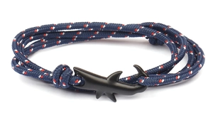 Detail of nautical braided rope bracelet with a matte black shark-shaped hook closure