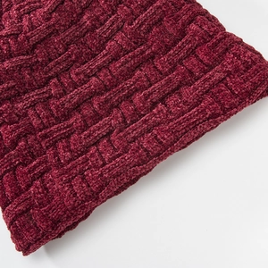 Vista macro del patrón de punto de chenilla rojo oscuro con textura gruesa para gorro