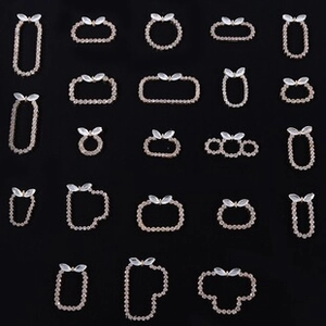 Detailed grid of champagne gold rhinestone DIY charms with white cat-eye leaf accents