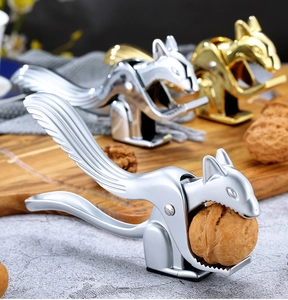 Squirrel-shaped nutcrackers in silver and gold finishes shown on a wooden board