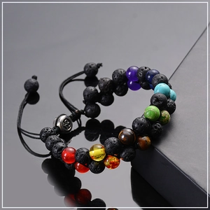 Detail of double-layer volcanic lava stone and chakra beads on adjustable braided bracelet