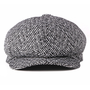 Classic black and white herringbone newsboy cap with textured wool knit octagonal design