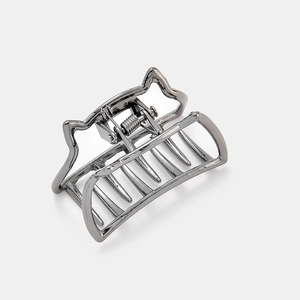 Detailed view of gunmetal hair claw clip with minimalist cat ear design and metal teeth