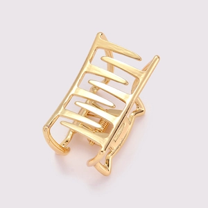 Detailed view of a golden rectangular hollow metal hair claw clip with sturdy spring