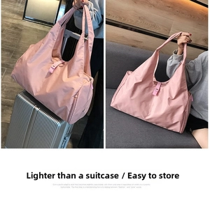 Pink foldable yoga travel bag detail showing the trolley sleeve attached to luggage