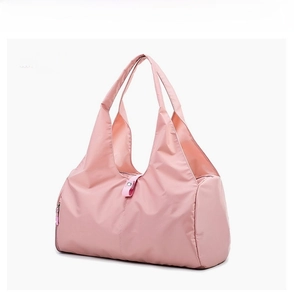 Detail view of pink large capacity waterproof travel bag with sturdy handles and side pocket