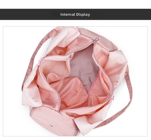 Internal view of pink waterproof yoga bag showing multiple compartments and zipper pockets