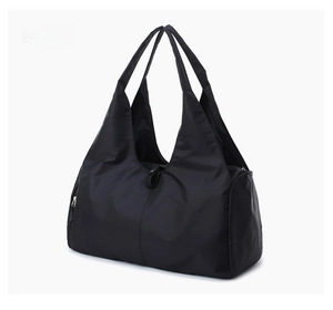 Detail view of durable black nylon tote bag with reinforced shoulder straps and side zipper