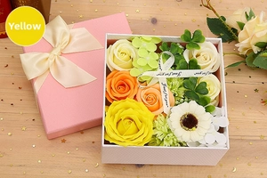 Top view of yellow soap flower gift box with roses, daisies and Just for you ribbon