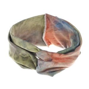 Detail of bohemian tie-dye elastic headband showing green and orange fabric texture
