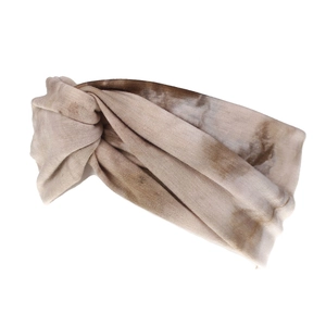 Detail of bohemian tie-dye wide headband showing ribbed texture and knotted design