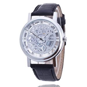 Detail of silver skeleton watch with visible gears and black embossed leather strap