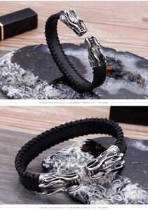 Detailed macro view of black braided leather bracelet with silver dragon head carvings