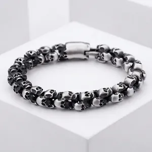 Retro punk style men's stainless steel bracelet featuring interlocking skull link chain