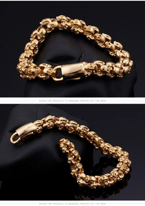 Detail of a punk style golden skull bracelet with high texture on black volcanic stone