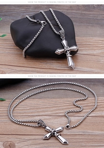 Macro shot of vintage silver cross pendant with rope design and steel box chain