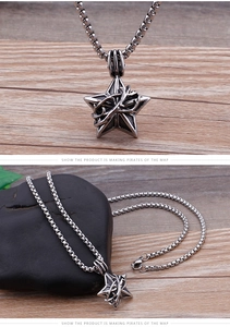 Macro shot of vintage stainless steel star pendant with gothic vine textures and box chain
