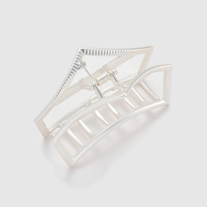 Minimalist silver geometric hollow hair claw clip with modern metal design on white background