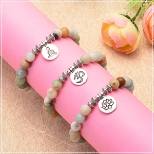 Macro detail of 8mm Amazonite beads with Buddha, Lotus, and Om charm yoga bracelets