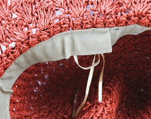 Macro shot of sun hat inner adjustable drawstring and breathable woven fiber texture