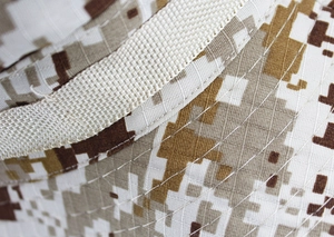 Detail of desert digital camouflage ripstop fabric with reinforced stitching on sun hat