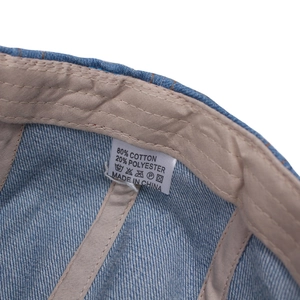 Internal details of washed denim beret featuring cotton lining and quality stitching
