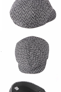 Detail showing herringbone patterns and label of a 65% cotton knit newsboy cap