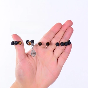 Strong elastic cord detail showing durability of volcanic lava and tiger eye bead bracelet