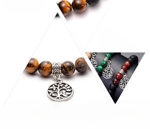 Macro detail of handmade energy stone bracelets featuring a silver tree of life charm