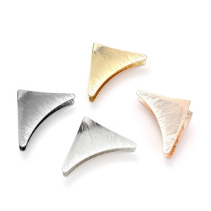 Detail of geometric triangle hair clips in gold, silver, gun black, and rose gold finishes