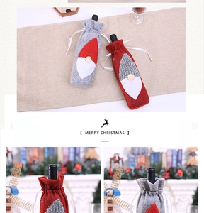 Detail of red and grey knitted gnome wine bottle covers with Merry Christmas embroidery