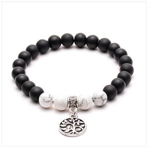 Detail of beaded yoga bracelet with lava stones, white turquoise and Tree of Life charm