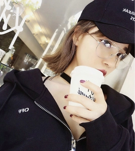 Close-up of lifestyle fashion look featuring oversized pilot glasses and black hoodie