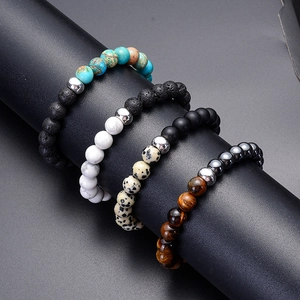 Set of 8mm tiger eye, turquoise, and lava rock beaded bracelets on a black display stand