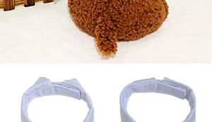 Detail view of brown plush faux fur fabric and white fabric pet collar texture