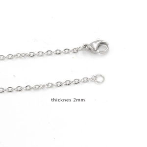 Macro view of 2mm silver stainless steel cross chain with lobster clasp detail