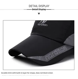 Macro detail of black baseball cap showing the structured brim and performance fabric