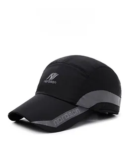 Detail of norason winter cap featuring black windproof fabric and grey striped accents