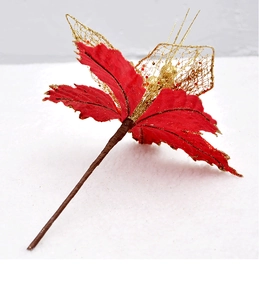 Macro view of red fabric Christmas flower with gold glitter trim and mesh leaf detail