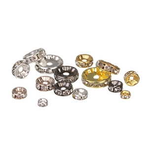 Close-up of multicolored rhinestone spacer beads in gold and silver for DIY jewelry