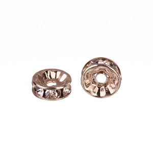 Macro view of rose gold rhinestone spacer beads for DIY jewelry making and bracelet crafts