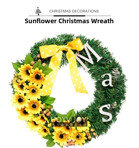 Detail of Christmas wreath with yellow sunflowers, pine needles, and a polka dot bow