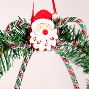 Green Christmas wreath with red felt Santa Claus and spiral ornaments for home wall hanging